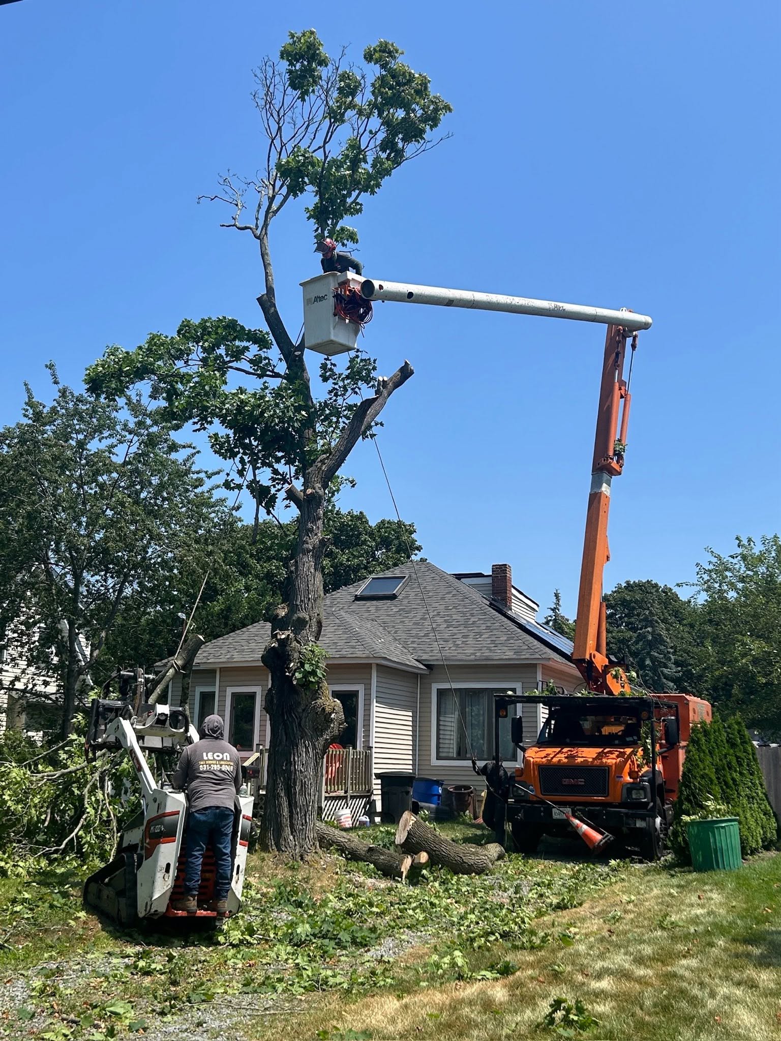Morning Star Tree Co. Altec aerial bucket truck and Bobcat loader on site